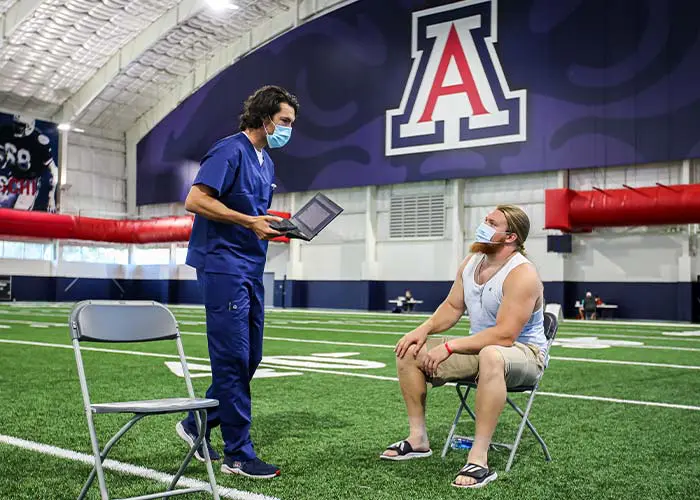 Doctor and athlete on field